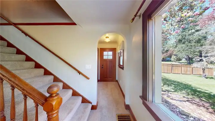 From living room looking past stairs to side entrance