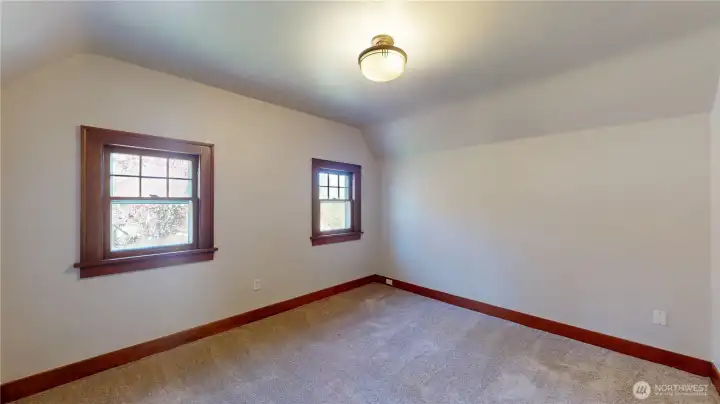 Bedroom number two overlooks that front yare and is very large. This photo is taken from the entry door to the bedroom.