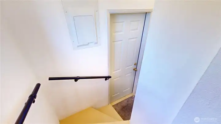 Stairs leading to the back door and basement from the kitchen nook