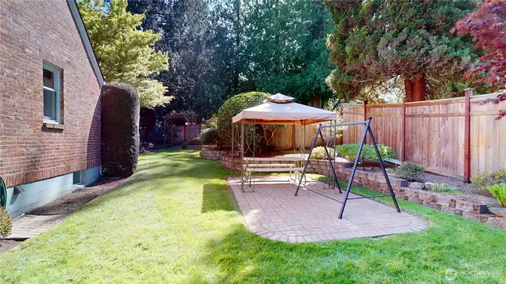 The side yard with wonderful brick patio is perfect for outdoor entertaining