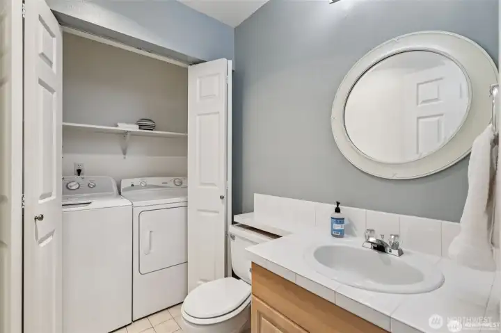 half bath with full sized washer and dryer