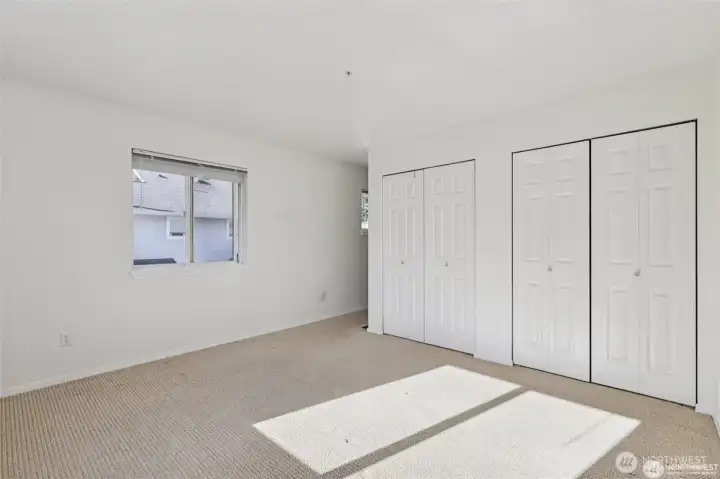 The primary bedroom is spacious with double closets