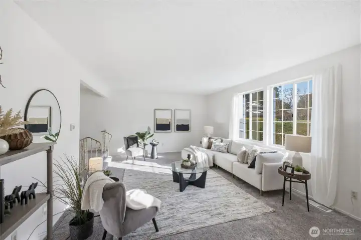 Set slightly below the main level, the sunken living room offers a cozy yet spacious setting ideal for relaxing or entertaining guests.