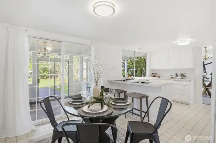 This charming dining area flows seamlessly into a sunroom.