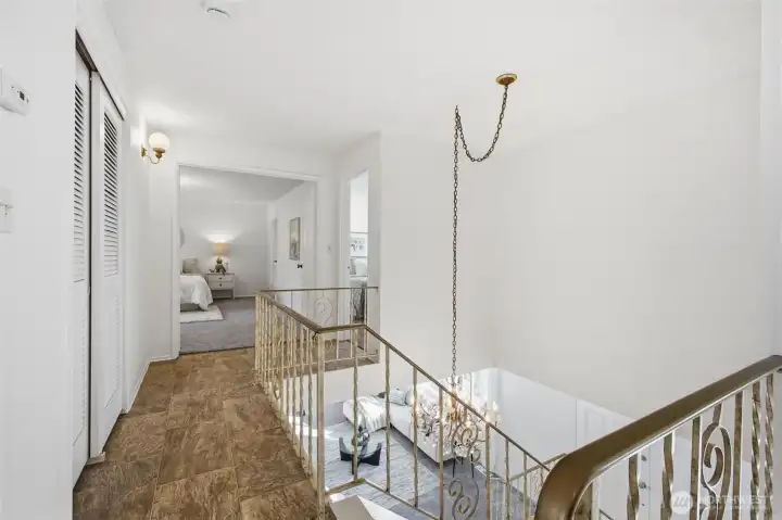A small overlook from the upstairs hallway adds a touch of openness, allowing glimpses of the main living areas below.