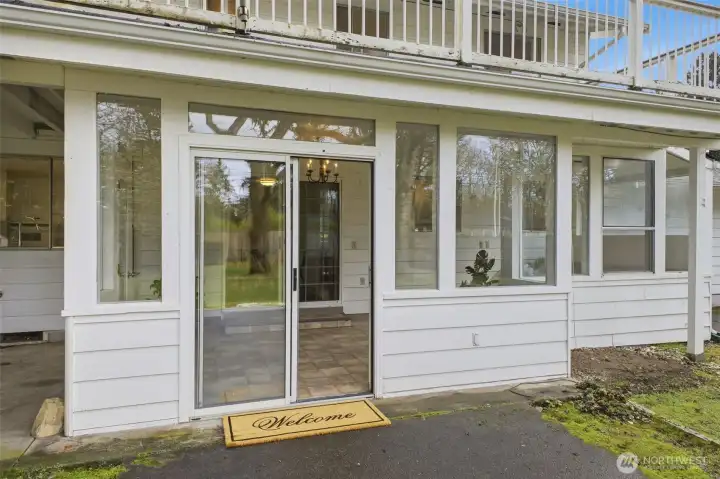 Access to the sun room and inside of the home through the sliding doors.