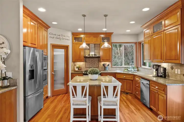 Kitchen boasts center island, extra serving/coffee bar, and additional table space.