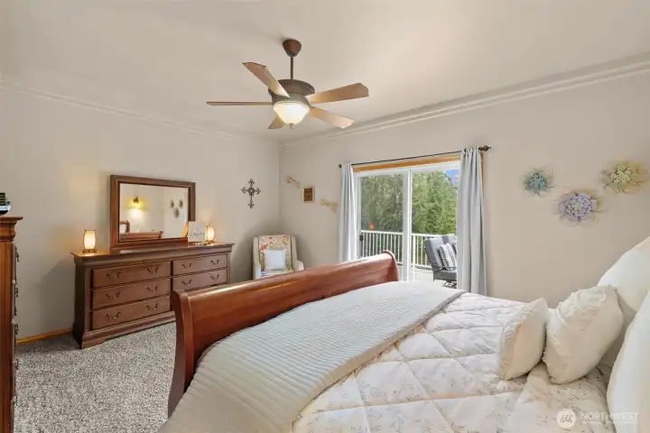 Primary retreat with crown molding, walk in closet, and its own access to the back deck.