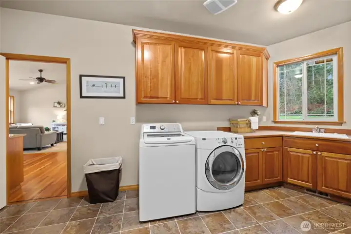 Laundry/mud room off the kitchen is a great pass through to the main garage. Plenty of cabinet/closet space.