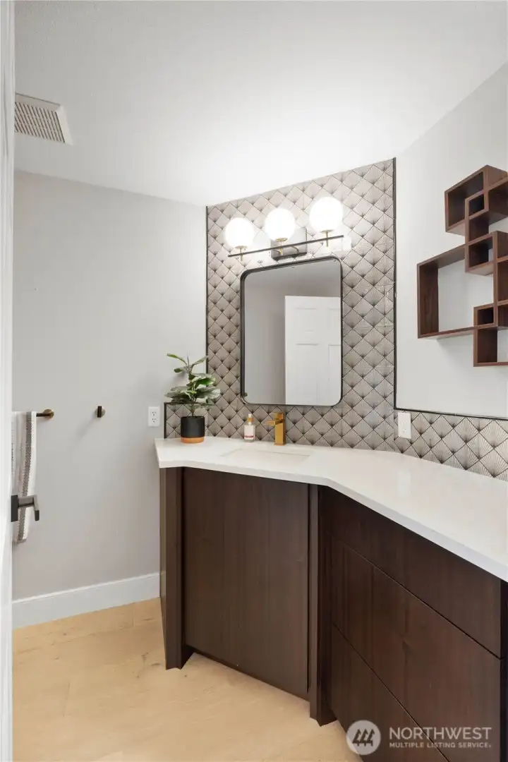 Updated main floor powder room with large vanity.