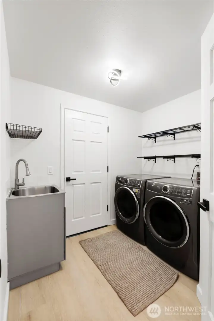 Laundry/Mud room with newer utility sink. Newer Washer/Dryer stay.
