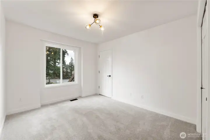 Second bedroom has door which leads to large storage room above garage.