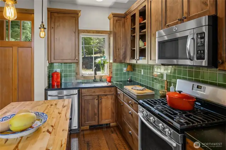 Custom tile backsplash, cabinets and butcher block island!