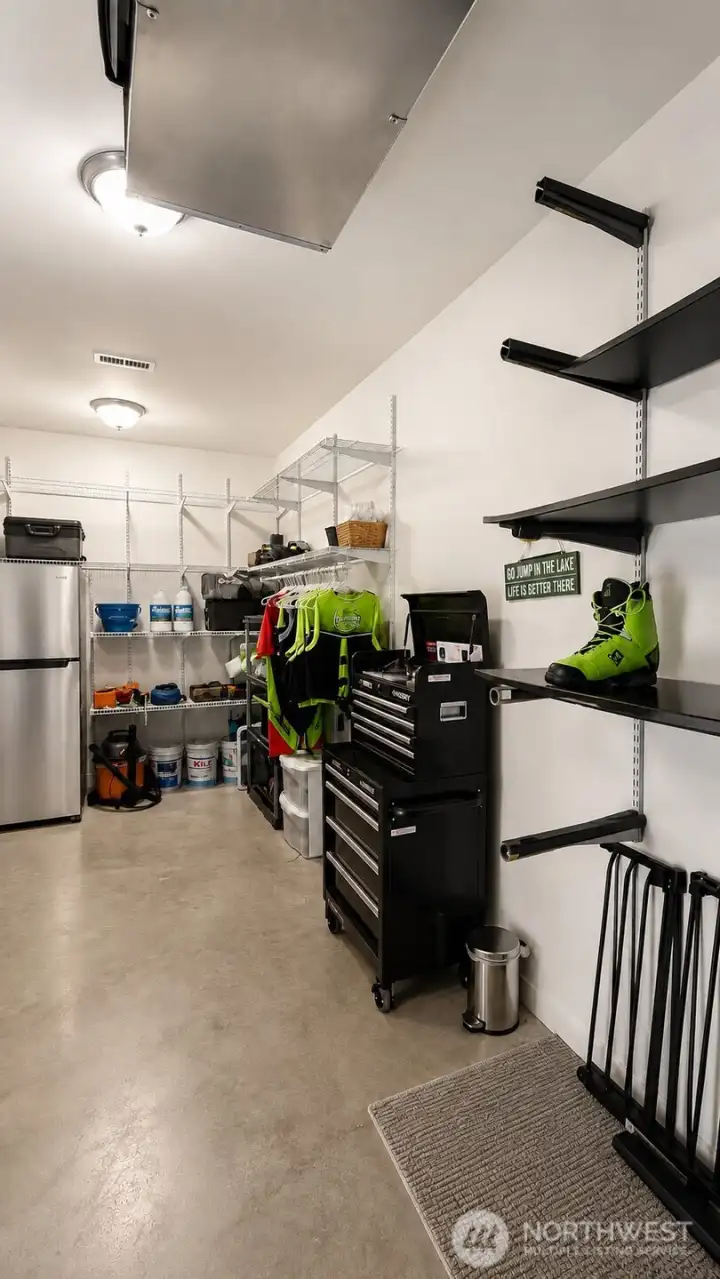 View of Lower Level storage room with refrigerator.