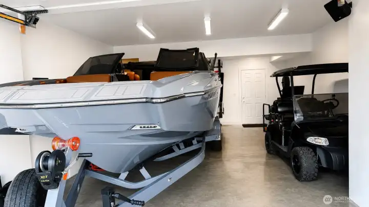 View of 16'x30' garage with 12' doors, perfectly designed to house a wakeboarding boat, golf cart, exercise equipment, toys and more.