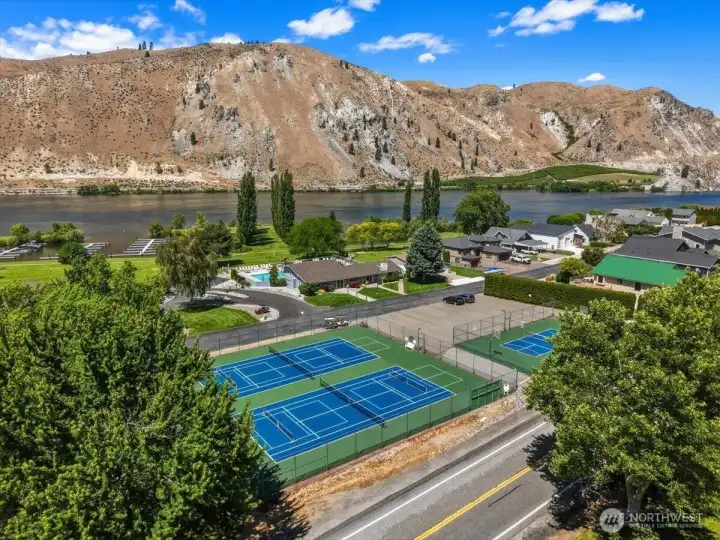 Aerial view 2 of Sun Cove community waterfront with sports courts, clubhouse, pool, boat launch, marina, parks and playgrounds.