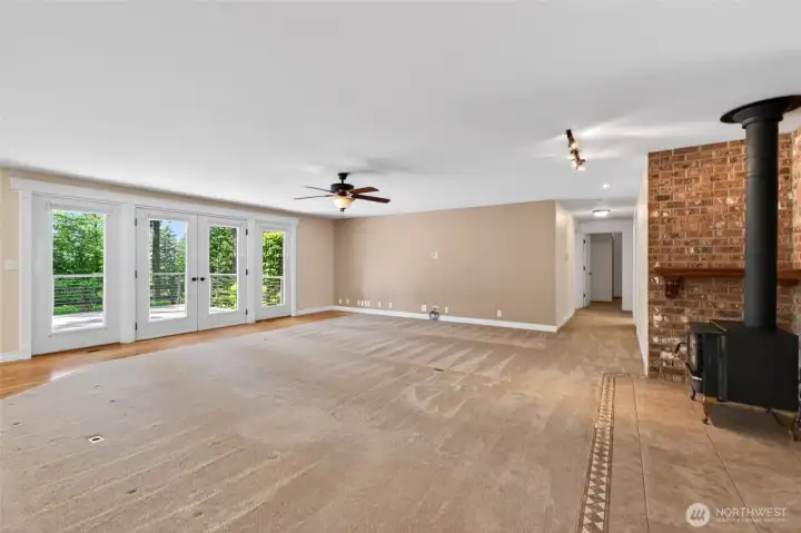 The expansive open-concept design offers endless possibilities for your personal style and décor. French doors open to a spacious deck, seamlessly blending indoor and outdoor living while creating the perfect space for entertaining and gathering with family and friends.
