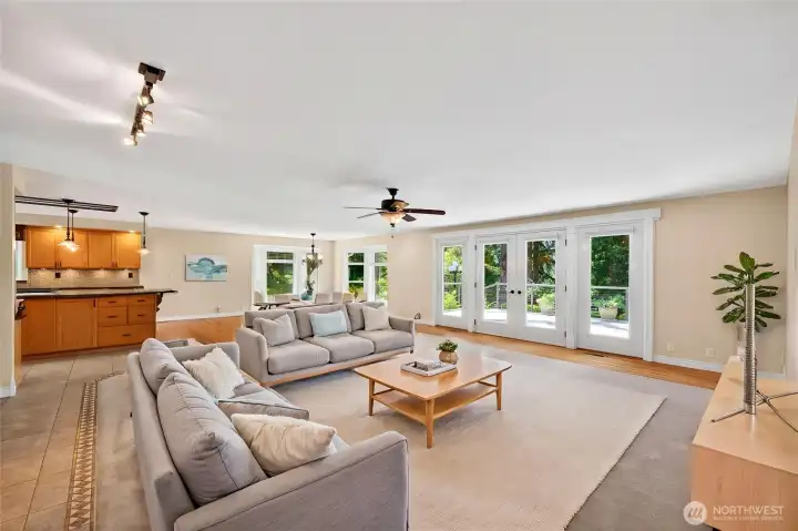 Shown with virtual staging, this inviting space is the perfect place to relax, sink into the sofa, and take in the beautiful views beyond.