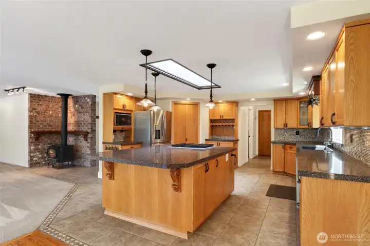 Thoughtfully designed for both style and function, the kitchen showcases solid surface countertops, stainless steel appliances, a built-in wine rack, and a walk-in pantry, enhanced by layered lighting for everyday living and entertaining.