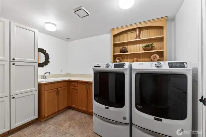 The utility doom is conveniently located just off the garage entrance and serves as a mud room and additional storage.
