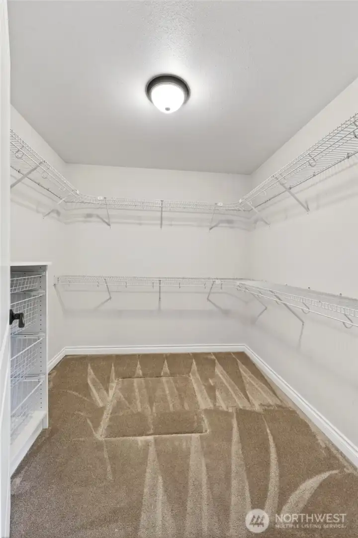 A spacious walk-in closet completes the primary suite, providing generous storage and convenience.
