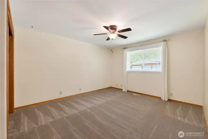 One of the two guest bedrooms features a generous layout, offering comfort and flexible use for guests or additional living space.