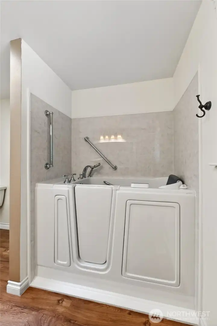 The full guest bath is thoughtfully appointed with a walk-in jetted tub, blending comfort, convenience, and functionality.
