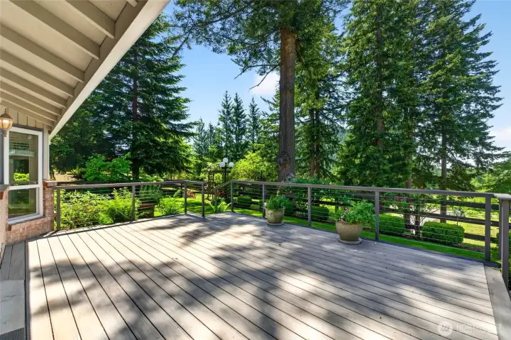 This expansive deck speaks for itself, offering sweeping views of the beautifully landscaped grounds from every angle. Perfect for summer BBQs, entertaining, or enjoying a quiet morning coffee.