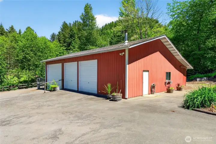 This impressive shop delivers abundant space for projects and storage, with an oversized tall bay designed to comfortably accommodate an RV, boat, or large equipment.