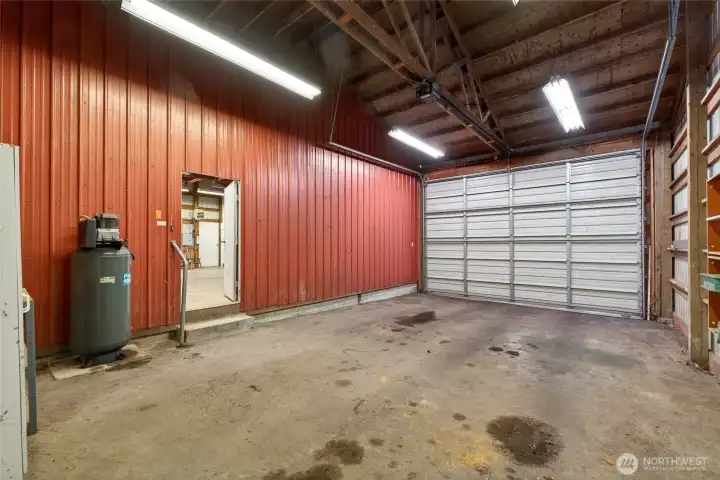 The third oversized bay connects seamlessly to the main shop, showcasing impressive height and width ideal for an RV, boat, or large equipment. An air compressor is also included, providing convenience for all your power tool needs.