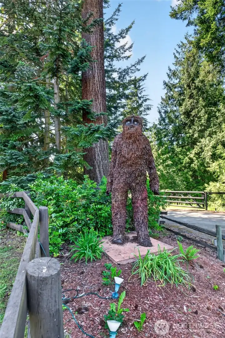 Painstakingly crafted by the seller, a whimsical Sasquatch adds character to the property, creating a memorable and welcoming conversation piece for guests.