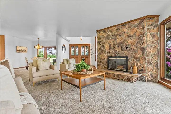 The living room features a lovely wood burning fireplace.