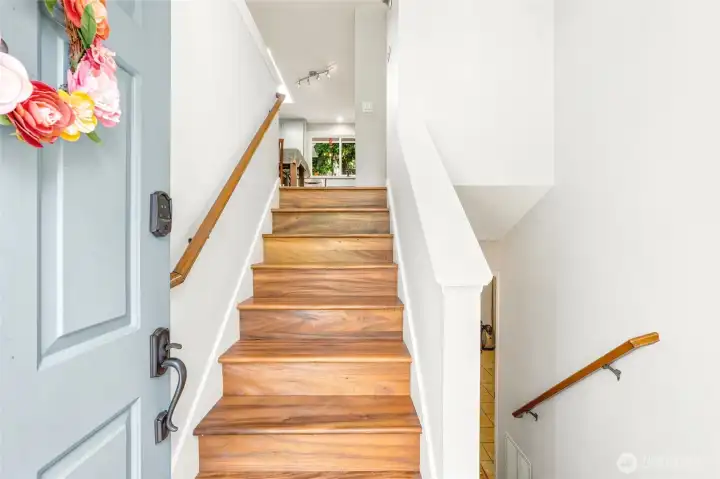 Split level entry with updated acacia hardwood floors.