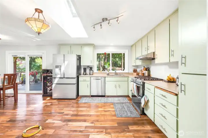 Open concept kitchen with electrical wiring for a kitchen island complete.