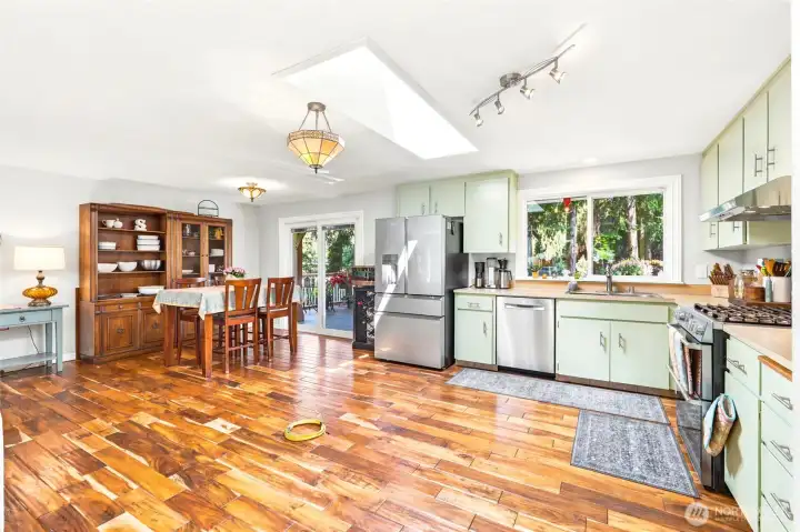Open concept living flows from kitchen to dining.