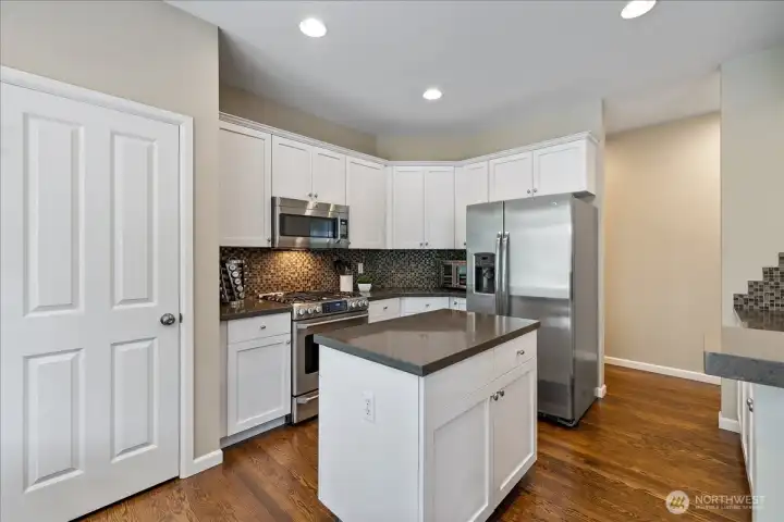 Chefs' kitchen with pantry and plenty of cabinetry.