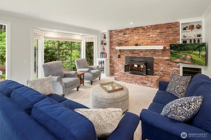 Family room with wood burning fireplace and bay window Family room with wood burning fireplace and bay window