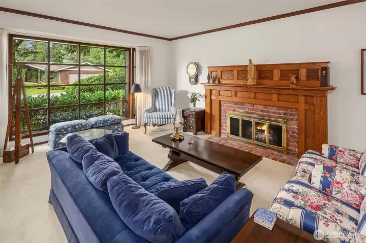 Sunken Great Room w/ wood burning fireplace and large picture window Sunken Great Room w/ wood burning fireplace and large picture window