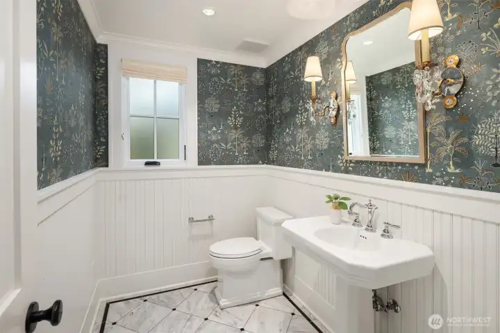 Main floor powder room with designer wall paper and stylish sconces. Main floor powder room with designer wall paper and stylish sconces.
