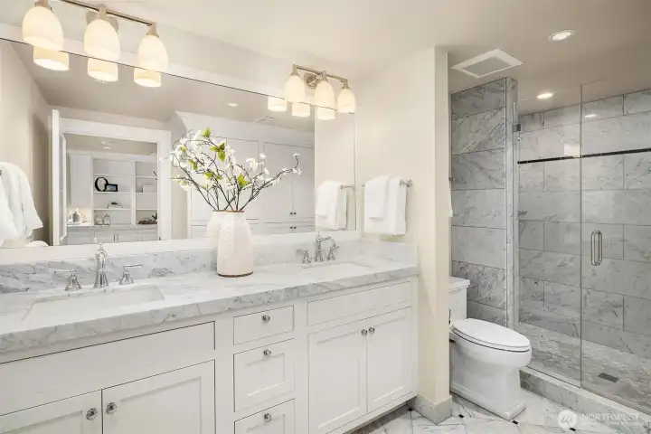 Generously sized bathroom- two sinks and a large shower. Linen closet reflected in the mirror. Generously sized bathroom- two sinks and a large shower. Linen closet reflected in the mirror.