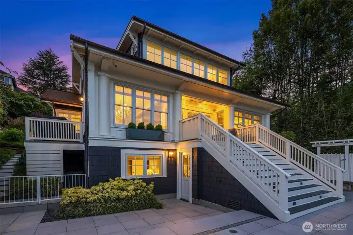 A view back to the house- stairs on the left to the side deck. The middle stairs lead to the covered heated patio and a gate on the right to the garage. A view back to the house- stairs on the left to the side deck. The middle stairs lead to the covered heated patio and a gate on the right to the garage.
