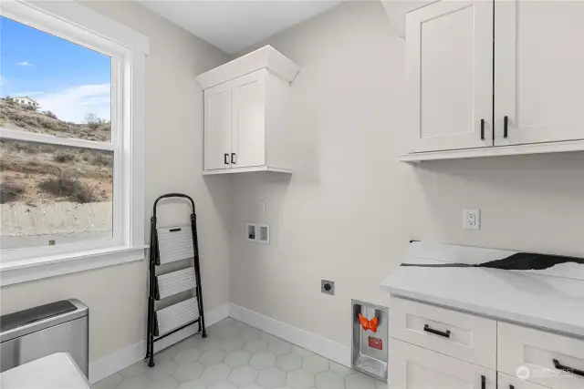 The utility room is located at end of hallway on the upper level.