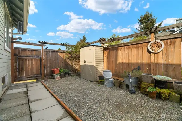 Low-maintenance back yard is set up to entertain with a bbq area and hot tub!