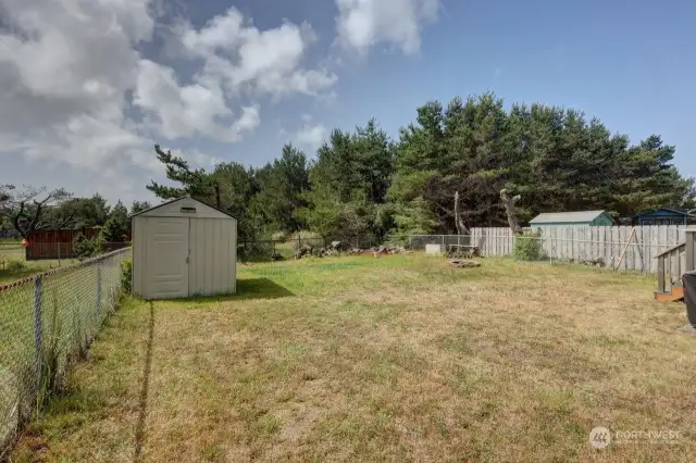 Fenced backyard with storage shed