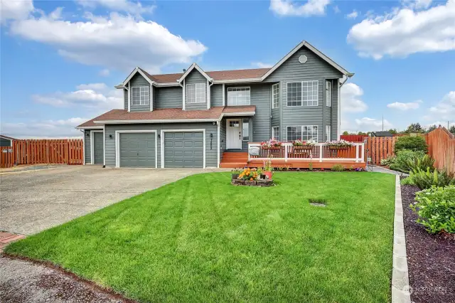 luscious green lawn  perfectly edged, along with concrete curbing, very nice