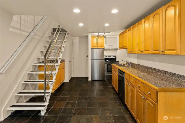 Bathed in radiant natural light from an expansive floor-to-ceiling wall of high-efficiency southwest-facing windows, this one-bedroom loft condominium invites you to revel in an airy, open design with a breathtaking 14-foot ceiling. A unique city treasure, it offers an elevated view over a lush embankment of mature maples, infusing every moment with tranquility. Perched above a quiet street, it feels like a hidden sanctuary, yet places you effortlessly within reach of urban vibrancy. Whether as your personal retreat, a full-time city base, or a coveted rental, this Talisman loft merges sophisticated style, comfort, and an irresistible touch of nature—your own urban haven.