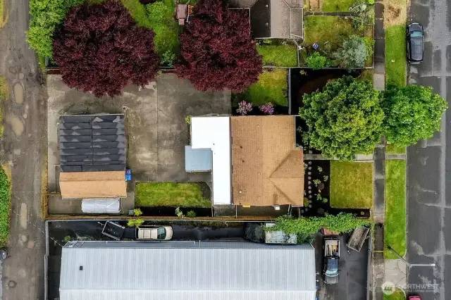 Aerial view of Main House and Detached garage. Large lot. Ample parking. 2 roads access front and back.
