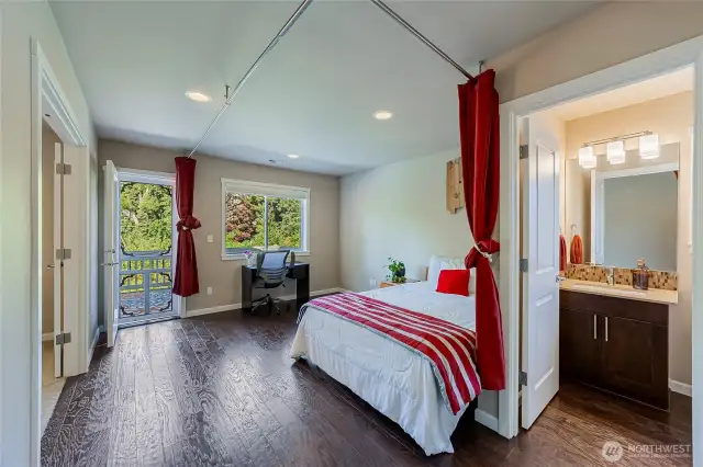 Upper level bonus area adjacent to the deck door that frames verdant greenery back of the home like art.