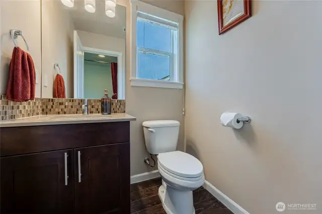 Upper level half bath with peek-a-boo water view.