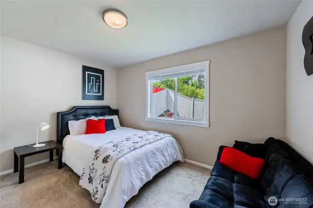 Good size entry level bedroom looking out to the backyard rock garden and corner floral platform. Entry level is not a basement. Light-filled and excellent ceiling height.